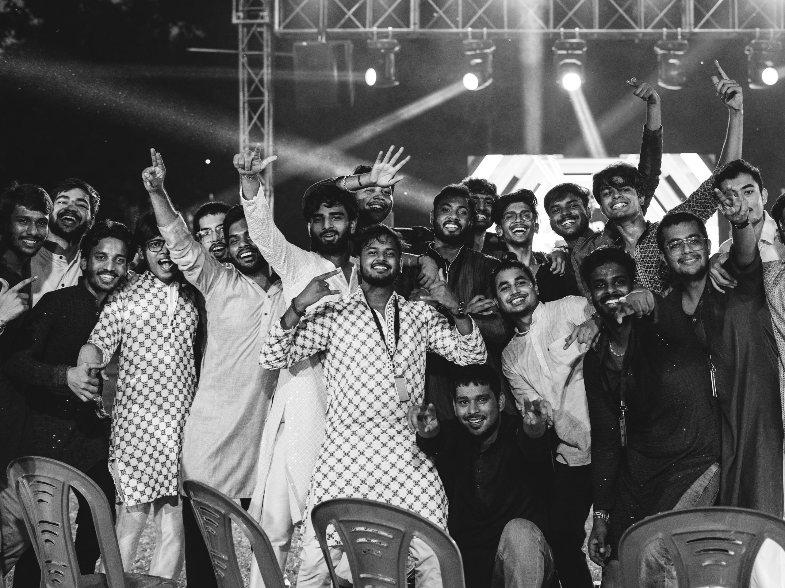 Black and white shot of a cheering crowd at the front of a stage