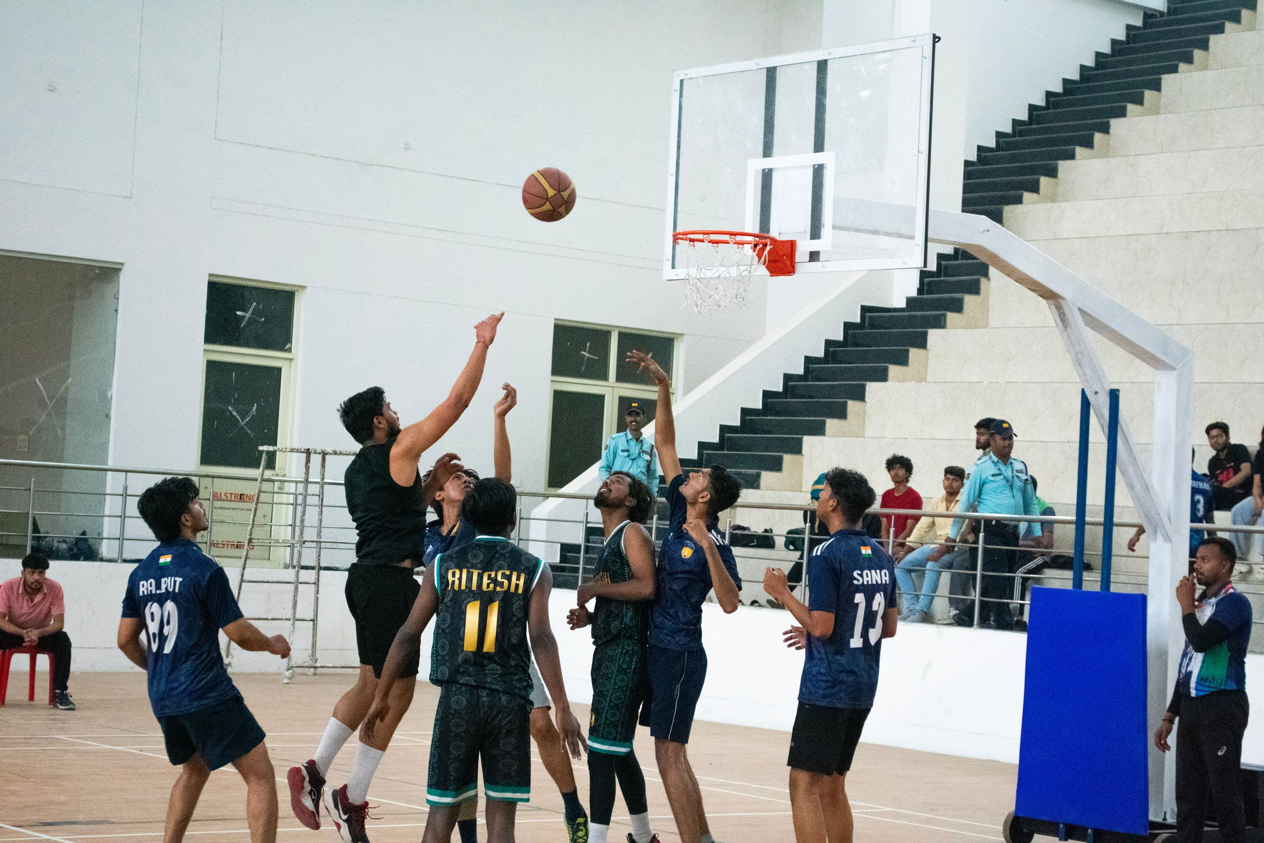 A basketball player rising for a shot on an indoor court