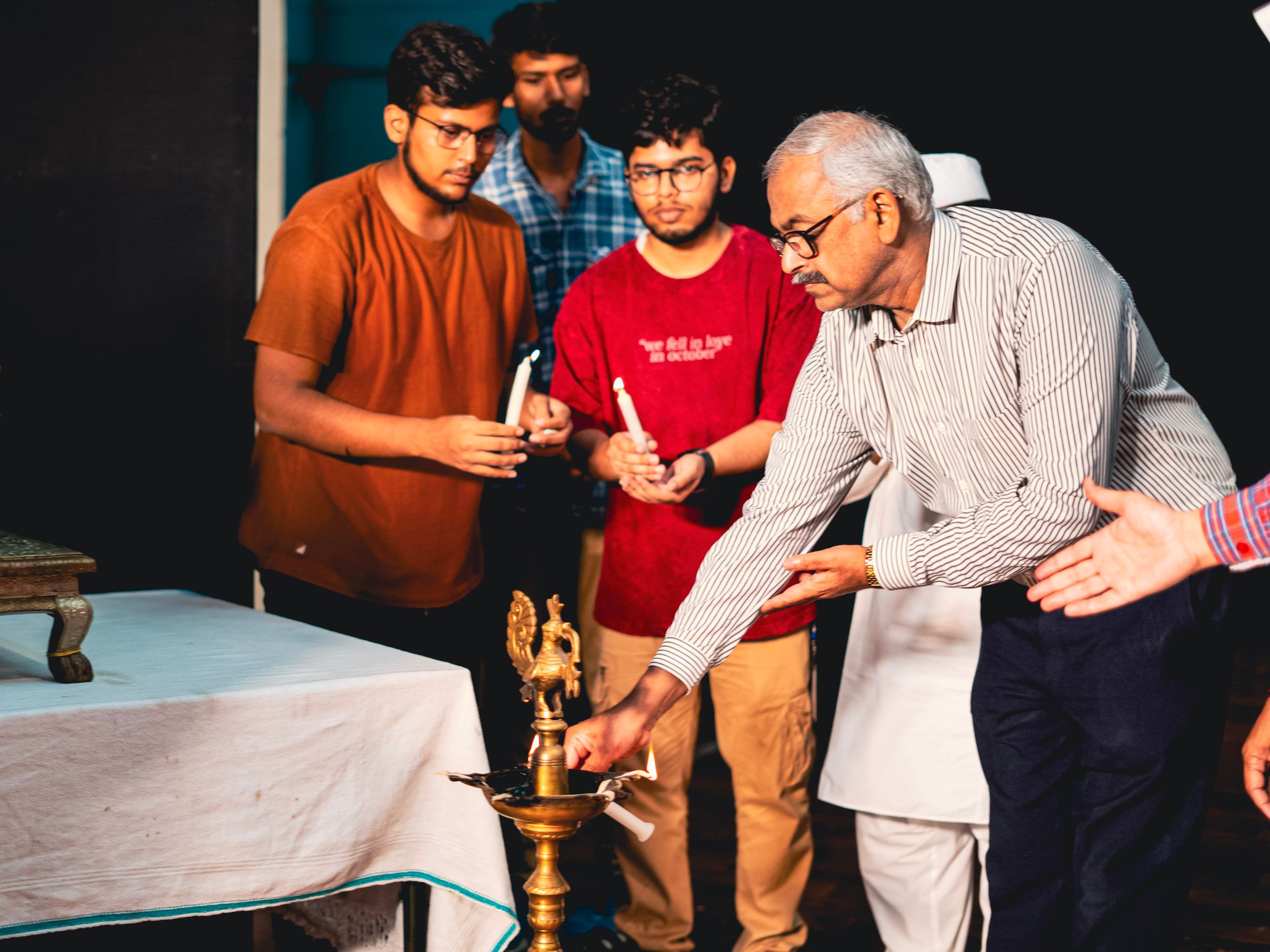 Guests lighting a ceremonial lamp at an inauguration