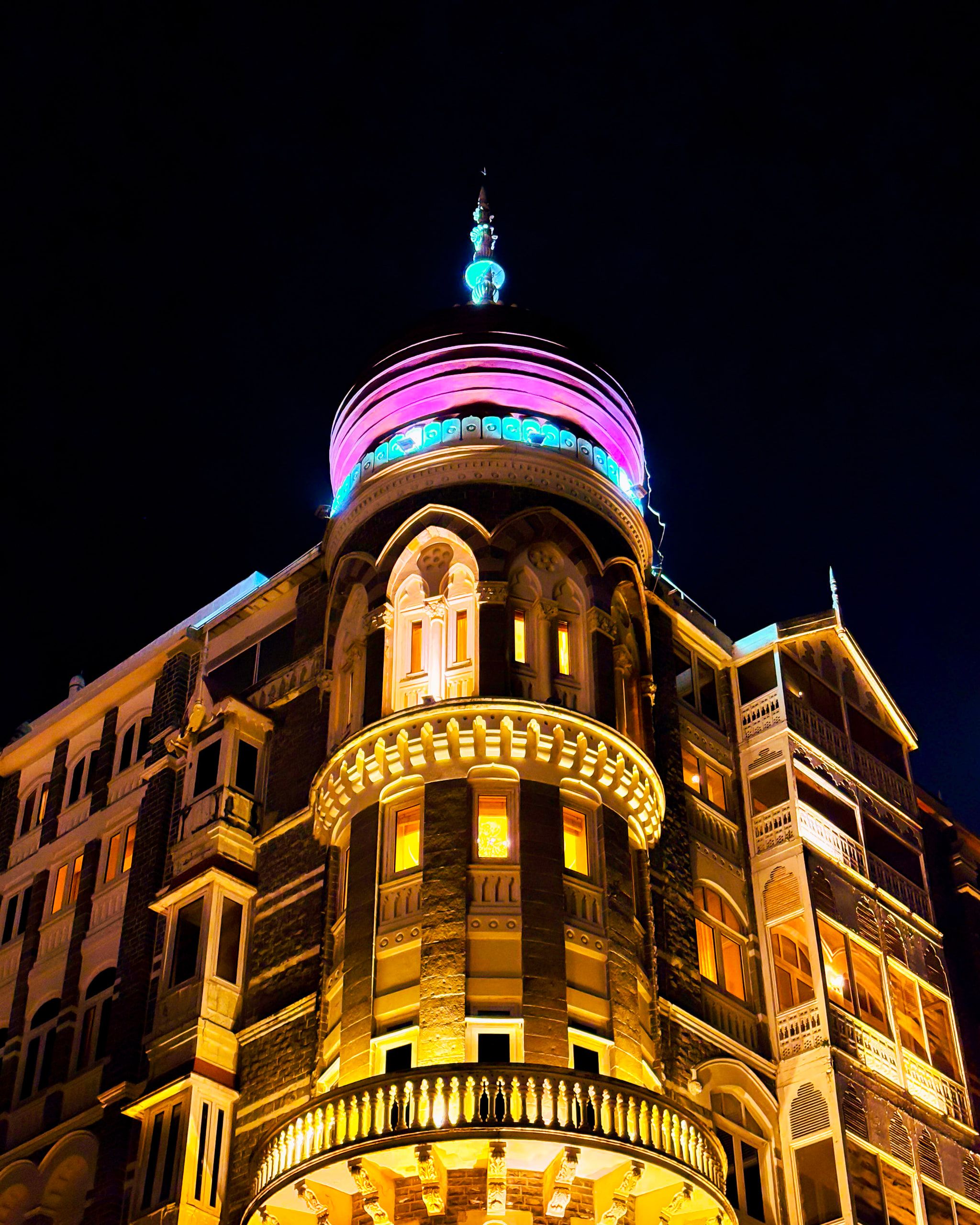 A heritage dome lit gold and pink against the night sky
