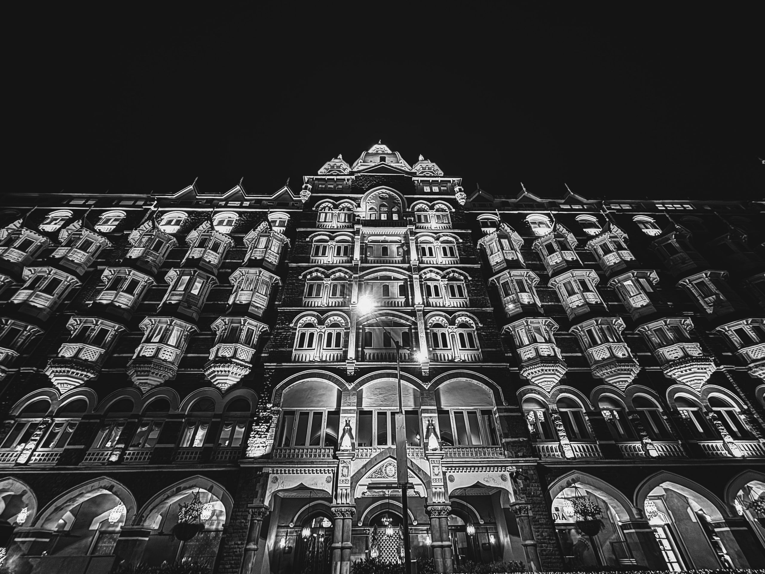 Black and white photo of a grand heritage facade lit at night