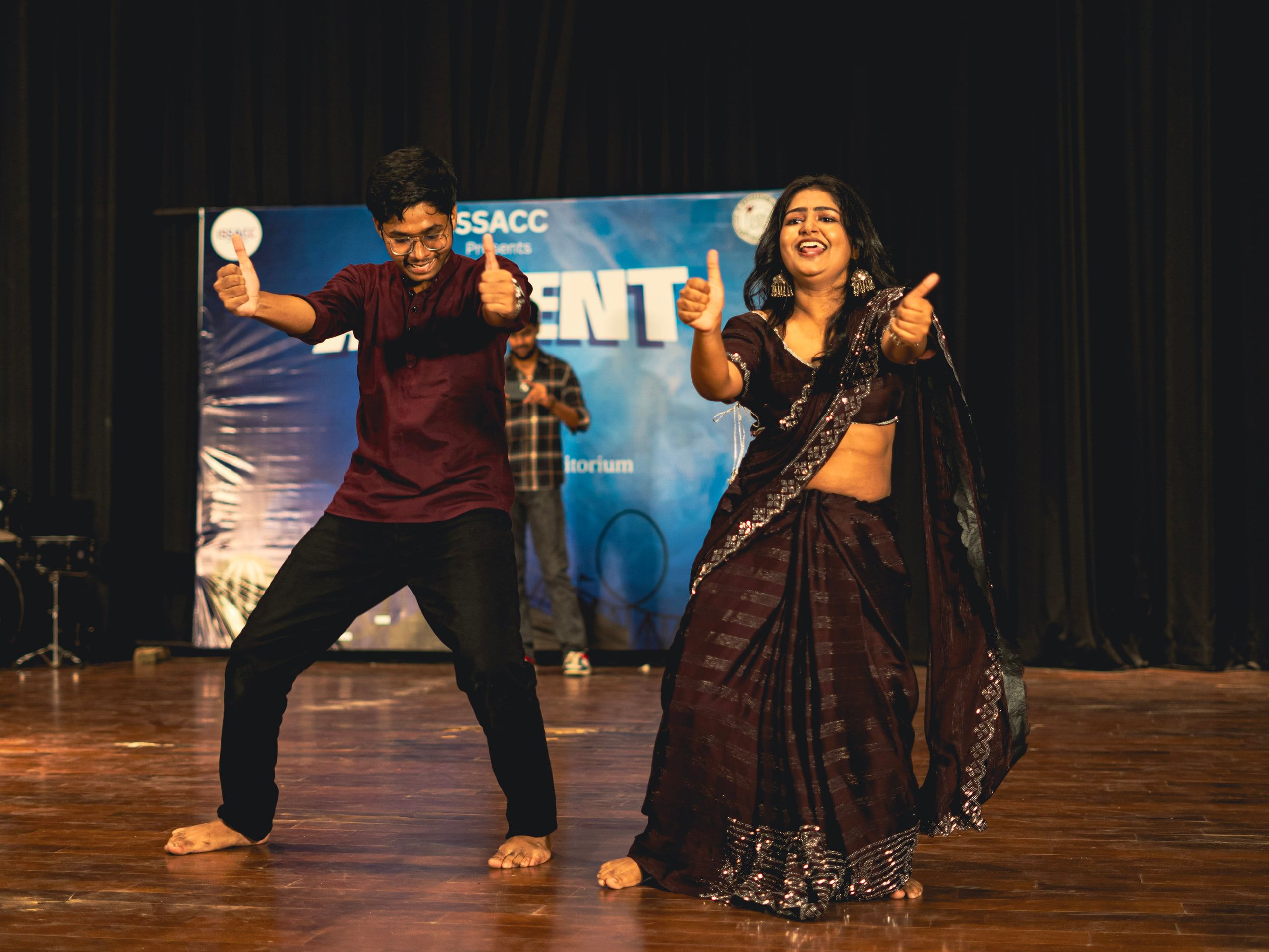 Two dancers striking a pose on stage