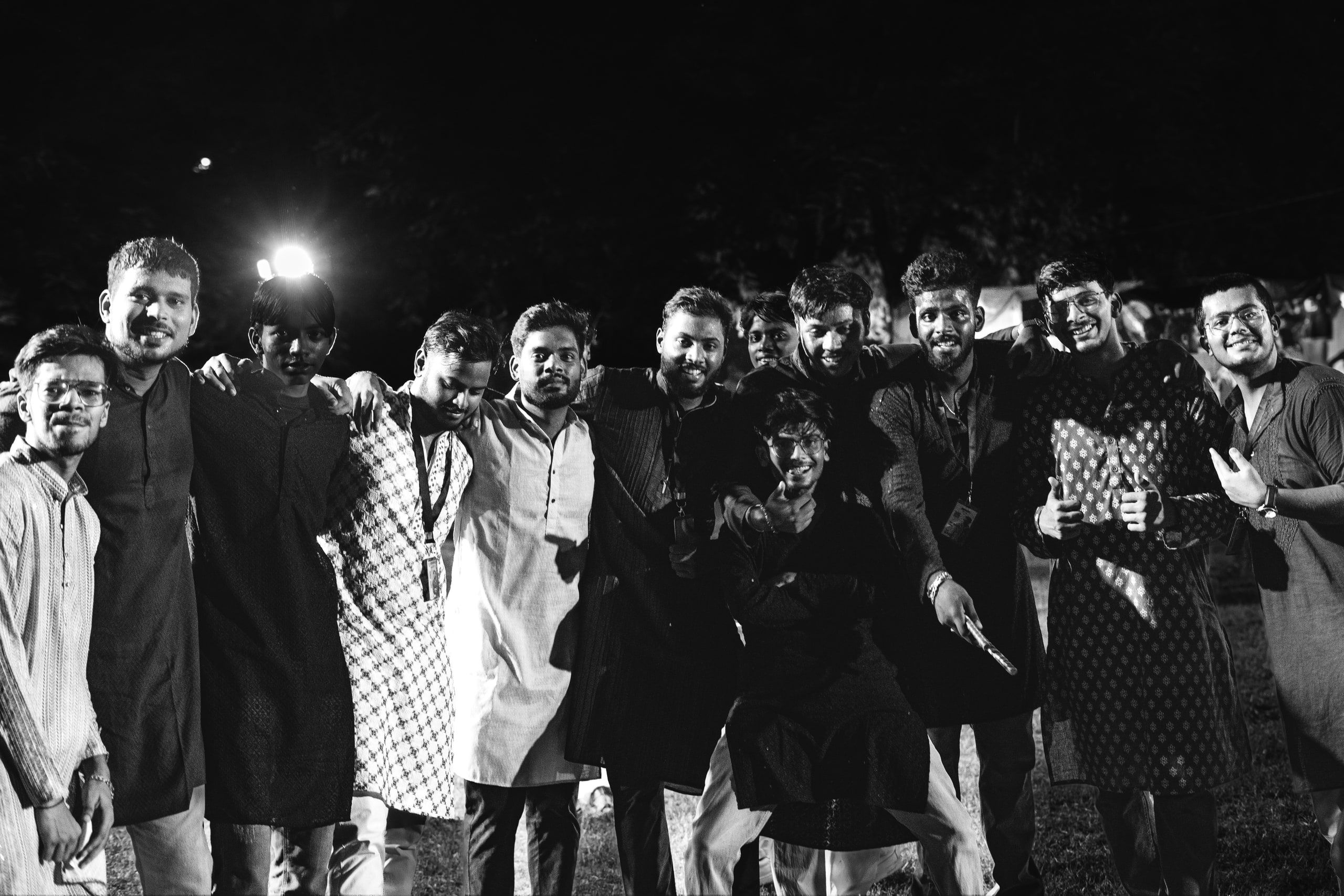 Black and white group photo of friends at night