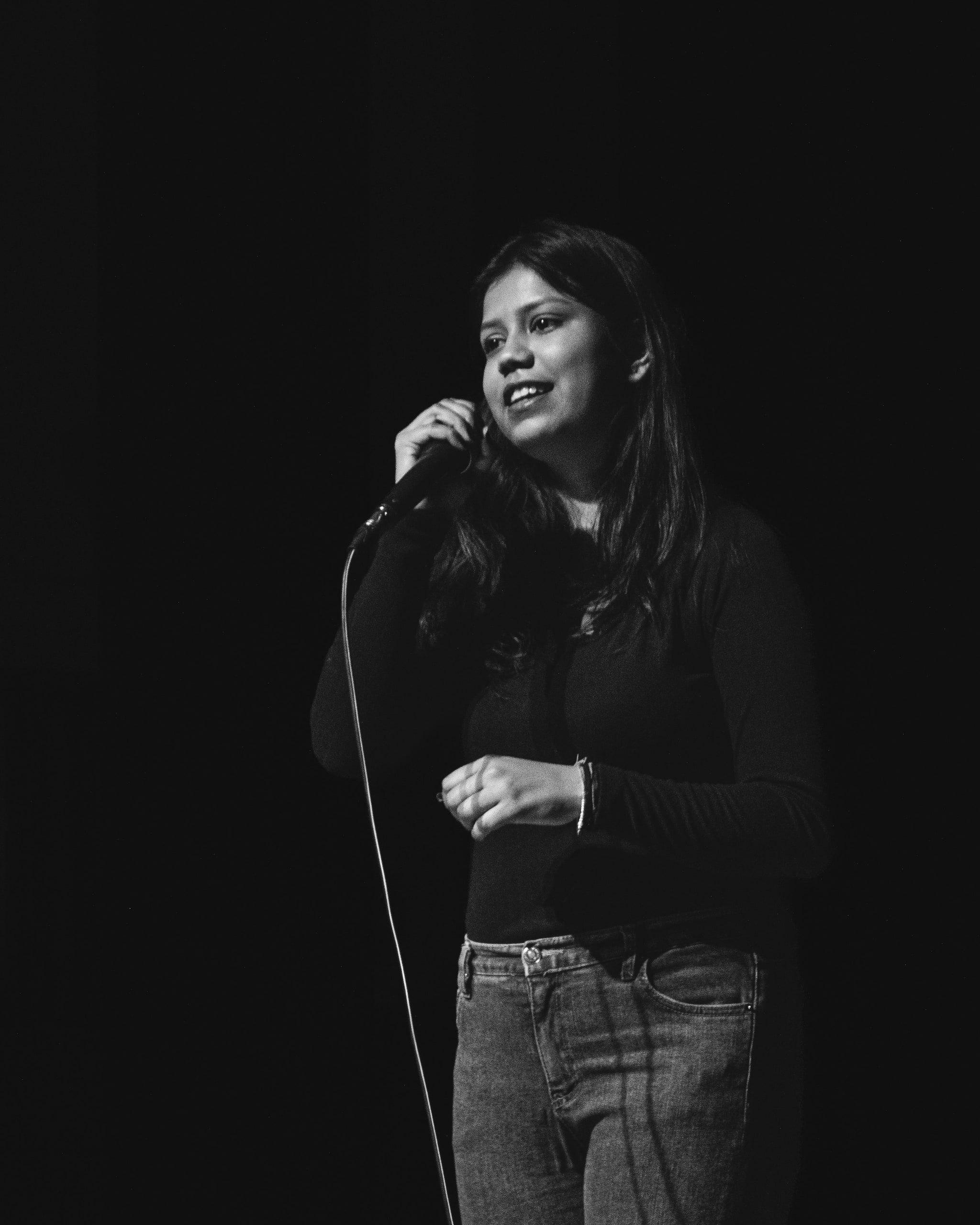 Black and white portrait of a singer holding a microphone
